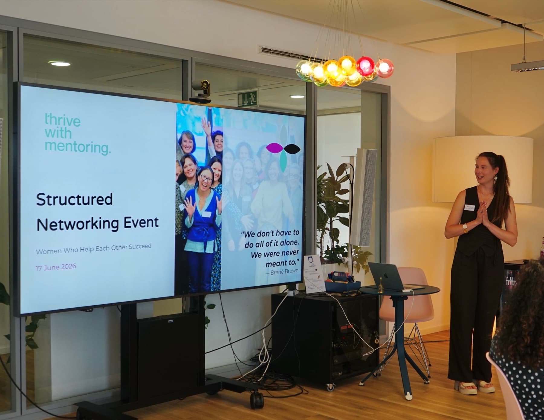 Margarita Dautova presenting at a Thrive with Mentoring Structured Networking Event, with the quote “We don't have to do all of it alone. We were never meant to.”